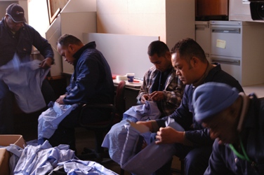 Students from Pacific Patrol Boat Project sort obsolete uniforms